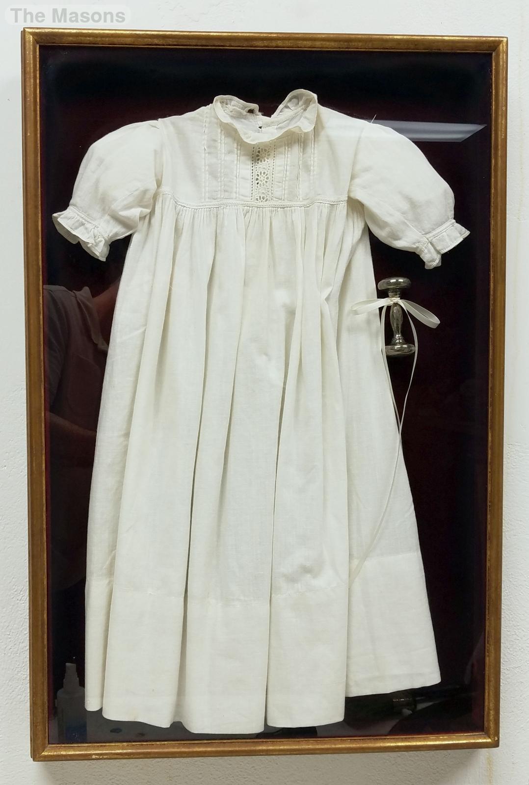 framing antique baby clothes